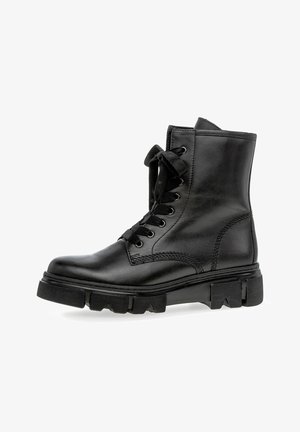Zwarte leren enkelboot met een ronde neus, stevige rubberen zool, vetersluiting aan de voorkant en tonal stiksels. Heeft een slank ontwerp.