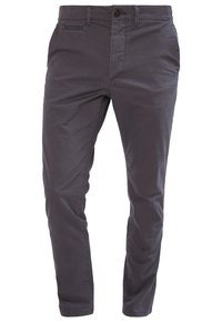 Chinos i mörkgrått. Tillverkade av bomullstyg, med framfickor, knappstängning och en smal, tapered passform. Slät textur.