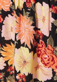 Black fabric featuring large, colorful floral patterns in shades of pink, orange, and yellow with green leaves; textured surface.
