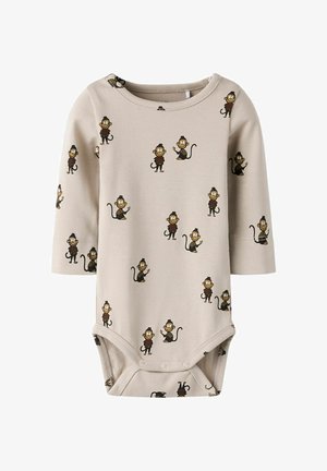 Body beige à manches longues en tissu doux, arborant un imprimé de singes ludiques dans différentes poses, avec une fermeture pressionnée au bas.