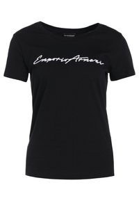 Camiseta de algodón negra con cuello redondo y mangas cortas. Presenta el texto en cursiva blanca "Emporio Armani" a lo largo del pecho.