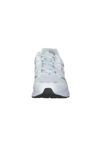 White athletic shoe with mesh panels, rounded toe, padded tongue, and black rubber outsole, featuring laces and minimal reflective accents.