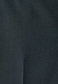 Dark blue textured fabric with a grid pattern, made from a smooth material, featuring subtle variations in shade and weave detail.