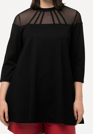 Black long-sleeve top featuring a sheer mesh neckline with vertical striping. The fabric appears soft with a relaxed, oversized fit.