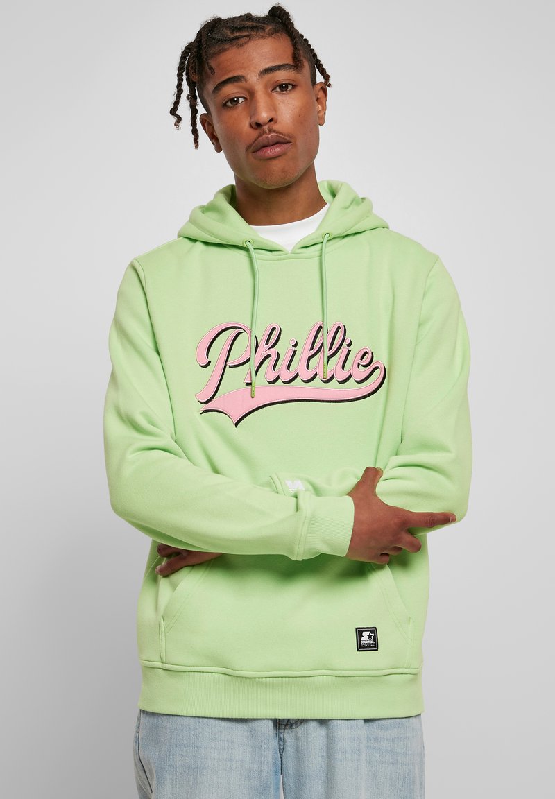Lys grønn hettegenser med frontlomme, med et rosa "Phillie" grafisk design. Mykt stoff med snor i hetten og ribbede mansjetter.