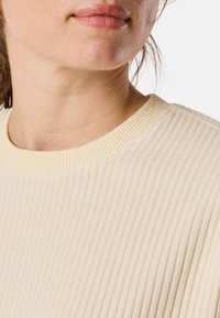 Lichtbeige geribde sweater met een ronde halslijn. Textuurstof met opvallende verticale lijnen en een zachte, relaxte pasvorm.