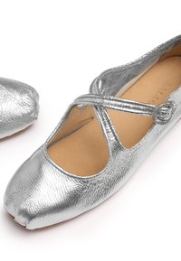 Zilverkleurige Mary Jane platte schoenen van textuurleer met een afgeronde gespleten teen en een kruisband met een ronde gesp.