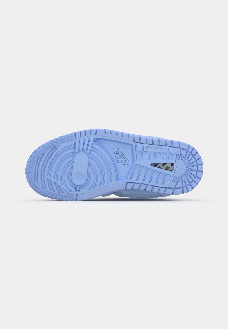 La semelle de sneaker bleu clair présente des motifs texturés, des designs circulaires et linéaires, avec un logo Nike et une construction en caoutchouc durable.