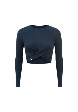 Tamsiai mėlynas ilgomis rankovėmis trumpas viršus, su suktos priekinės dalies dizainu. Pagamintas iš minkštos medžiagos su vientisa tekstūra ir mažo logotipo akcentu ant apačios.