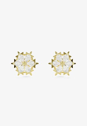 Para złotych kolczyków w kształcie sześciopłatowych gwiazd z przezroczystymi kamieniami przypominającymi diamenty, ułożonymi w geometryczne wzory.