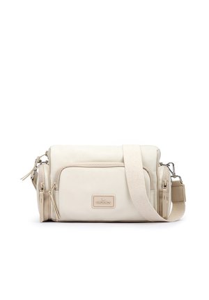 Sac bandoulière compact beige avec poche zippée à l'avant, compartiments latéraux et sangle en tissu réglable, marqué "Pikolinos" à l'avant.