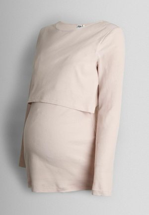 Pikkade varrukatega rasedustop pehmest ribakanga materjalist. Heleda beeži värvusega kihiliselt disainitud; rinna all tihedalt istuv mugavuse tagamiseks.