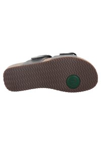 Gray sandal with a textured rubber sole and a brown base. Features two adjustable straps and a circular green logo on the bottom.