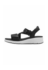 Sandalias de tela negra con correas ajustables, suela de cuña contorneada en negro y blanco, y detalles texturizados en las correas para mayor agarre.