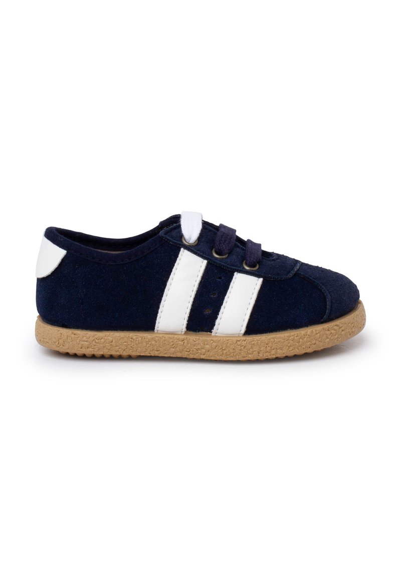 Navy blue felt shoe with white stripes, two-tone laces, and a textured light brown rubber sole. Rounded toe and low-cut design.