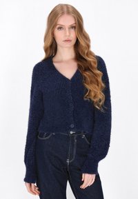 Granatowy krótkie sweter o miękkim, teksturowanym splocie, z dekoltem w serek, długimi rękawami i trzema guzikami na przodzie.