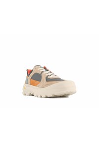 Zapatilla beige y gris con acentos naranjas, materiales de malla y cuero, suela gruesa blanca y un destacado detalle de cordones.