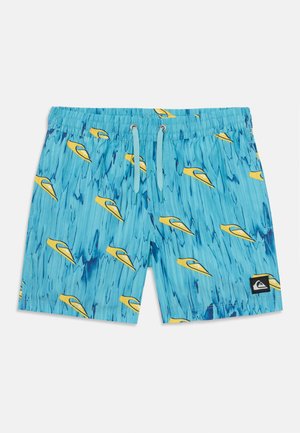 Blue swim trunks featuring a water-pattern design with yellow kayaks. Elastic waistband with drawstring and a black brand patch on the side.