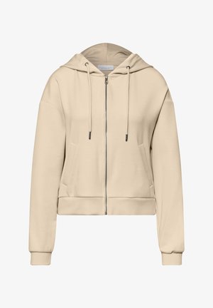 Beige hættetrøje med lynlås, snoretræk, forlommer, lange ærmer, elastiske ærmeafslutninger og hætte, vist på hvid baggrund.