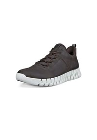 Bruna lädersneakers med vit gummisula, strukturerad ovandel, rund tå, snörning och separerade sektioner i sulan för flexibilitet.