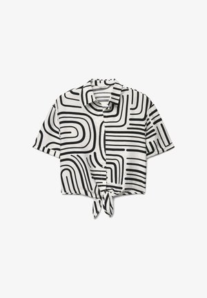Chemise blanche à manches courtes avec motif de lignes courbes abstraites noires et nœud noué à l'avant à l'ourlet.