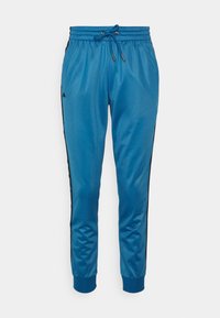 Pantalon de jogging athlétique bleu avec taille élastique, cordon de serrage, bandes latérales noires et poignets côtelés aux chevilles.