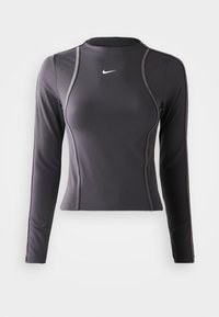 Langärmliges Sportoberteil in Dunkelgrau, aus dehnbarem Material, mit rundem Ausschnitt und kontrastierenden Nähten. Nike-Logo auf der Brust.
