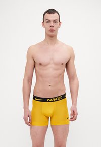 Nike Underwear TRUNK 3 PACK - Calzoncillos - uni gold/dark grey/blue void