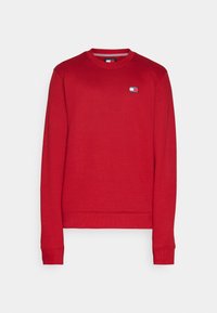 Sudadera roja de algodón, con cuello redondo, mangas largas, puños acanalados y un pequeño logotipo bordado en el pecho.