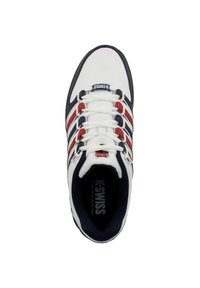 White athletic shoe with red and navy stripes, featuring a lace-up design, rubber sole, and "K-Swiss" logo on the tongue.