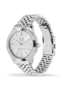 Reloj de acero inoxidable plateado con caja redonda, esfera blanca, función de energía solar y pulsera de eslabones. Las marcas incluyen "ice watch" y "Solar Power."