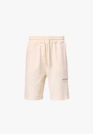 Kremowe bawełniane szorty z elastycznym pasem i sznurkiem, z bocznymi kieszeniami oraz małym szarym nadrukiem logo po dolnej lewej stronie.