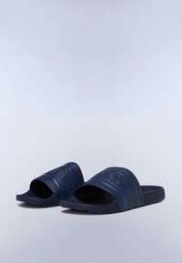 Blue rubber slides with wide straps featuring raised logo. Textured footbed and flat sole with ridged pattern for grip.