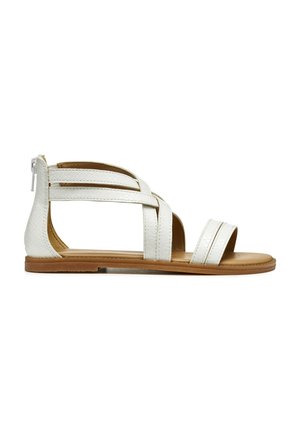 Sandalias de cuero sintético blancas con múltiples tiras cruzadas, puntera abierta, suela plana y cremallera trasera, con un acabado texturizado y plantilla en color marrón.