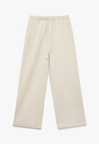 Beige weite Sweatpants mit einem Kordelzugbund, seitlichen Taschen und einem glatten Baumwollmischgewebe. Einfaches, lässiges Design.