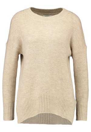 Beige kötött pulóver kerek nyakkivágással, bordás aljjal és enyhén eső vállakkal. Puha tapintású, laza szabású.
