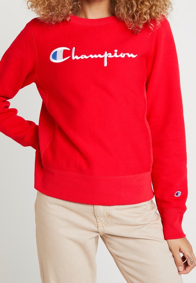 Rode sweatshirt van een katoenmix, met een witte geborduurde "Champion"-logo en een klein logo op de linkermouw. Ribgebreide halslijn en boorden.