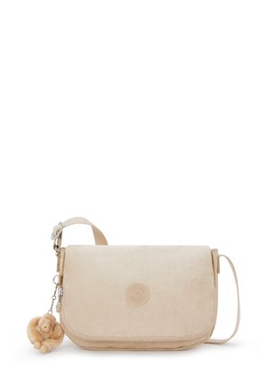Beige crossbody bag made of textured fabric with a flap closure, featuring a round logo and a playful monkey charm attached.
