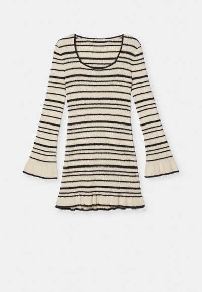 Cream striped knit top with black horizontal stripes, flared long sleeves, and a ruffled hem. Soft texture with a scoop neckline.