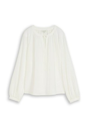 Blouse blanche à manches longues avec tissu froncé, encolure ronde et détail noué à l'avant, présentée à plat sur un fond blanc.