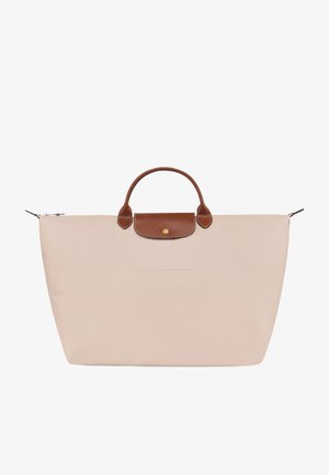 Light pink tote bag made of nylon with brown leather handles and a flap. Features a zip closure and a front pocket. Simple, functional design.