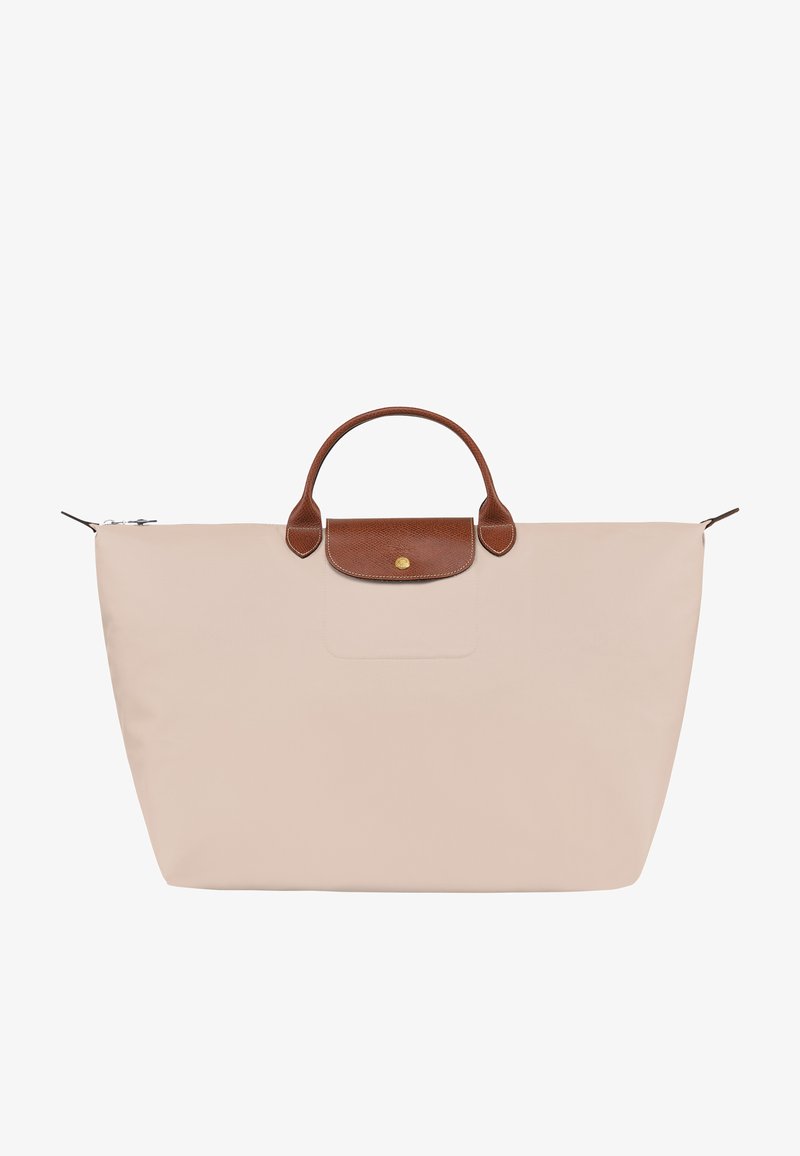 Light pink tote bag made of nylon with brown leather handles and a flap. Features a zip closure and a front pocket. Simple, functional design.
