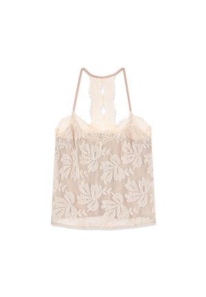 Camisole en dentelle beige transparente avec broderie florale et un délicat dos nageur en dentelle.