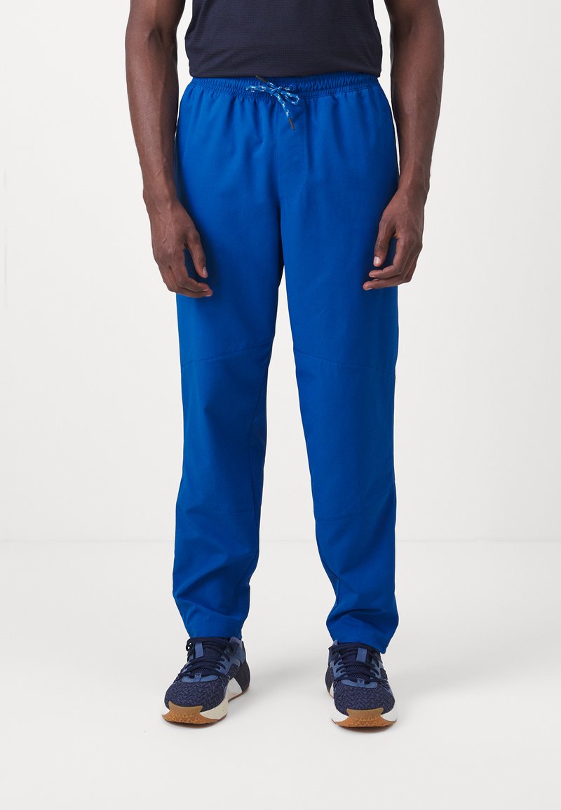 Pantalones ligeros azules con una cinturilla elástica y cordón, que presentan un corte holgado y puños ajustados, fabricados con un tejido suave.