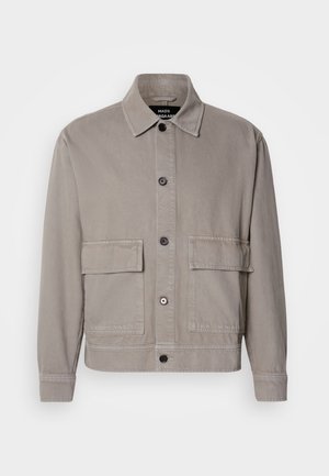 Light gray button-up jacket with pointed collar and two large flap pockets on the front, long sleeves, and visible stitching details.