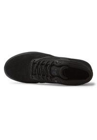 Black sneaker with textured suede upper, mesh panels, and black laces. Features a logo on the tongue and a rubber sole for traction.