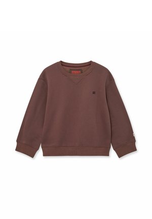 Rudas pūkuotas džemperis su apvalia apykakle ir banguotais manžetais. Savybė - mažas juodas logotipas ant krūtinės ir kontrastinga vidinė apykaklė.