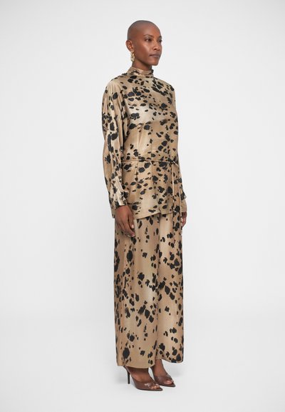 Leopard print satin outfit featuring a high-neck, long sleeves, and a flowy skirt; colors include beige with black spots and accents.
