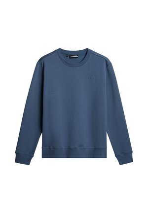 Niebieska bluza z okrągłym dekoltem, wykonana z miękkiej tkaniny. Posiada długie rękawy, ściągacze i teksturowane wykończenie. Minimalne logo na klatce piersiowej.