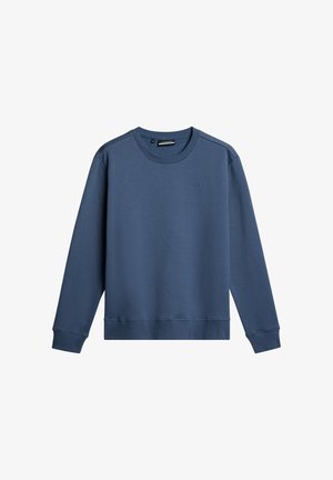 Niebieska bluza z okrągłym dekoltem, wykonana z miękkiej tkaniny. Posiada długie rękawy, ściągacze i teksturowane wykończenie. Minimalne logo na klatce piersiowej.